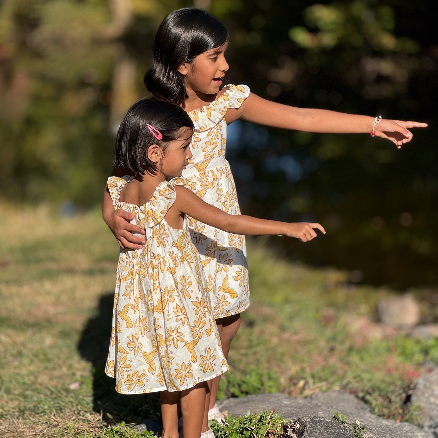 Two sisters twinning in handmade floral bird summer cotton dress