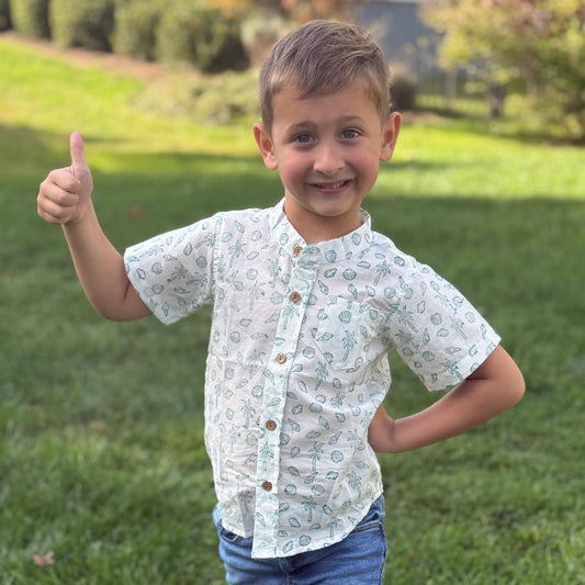 Boy wearing tropical print summer shirt
