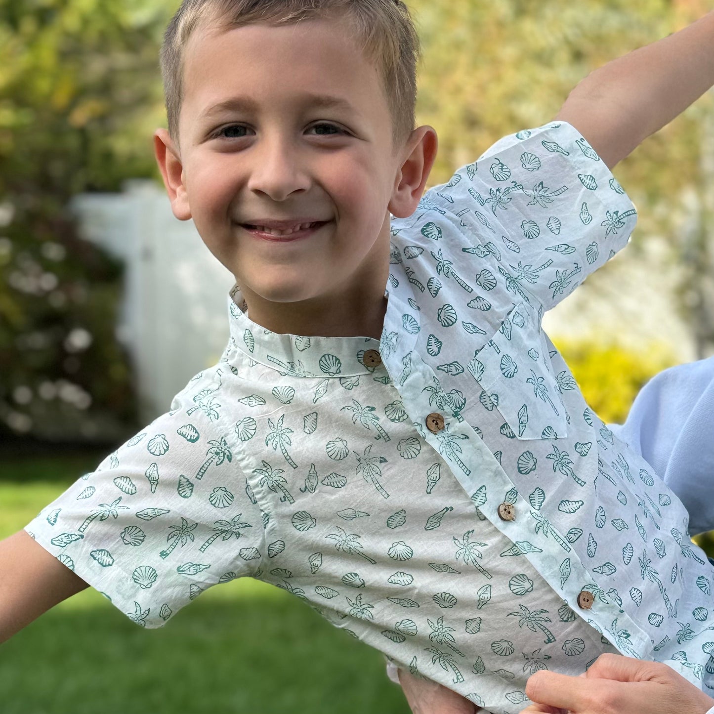 Toddler Boy wearing tropical print summer shirt