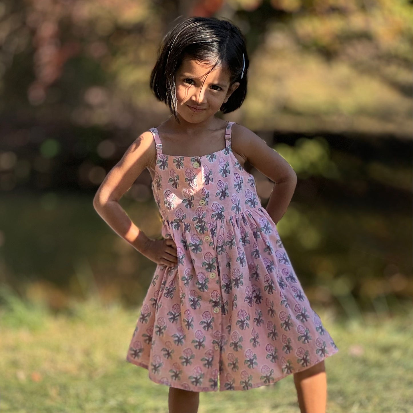 Girl standing in Pink flower summer cotton dress