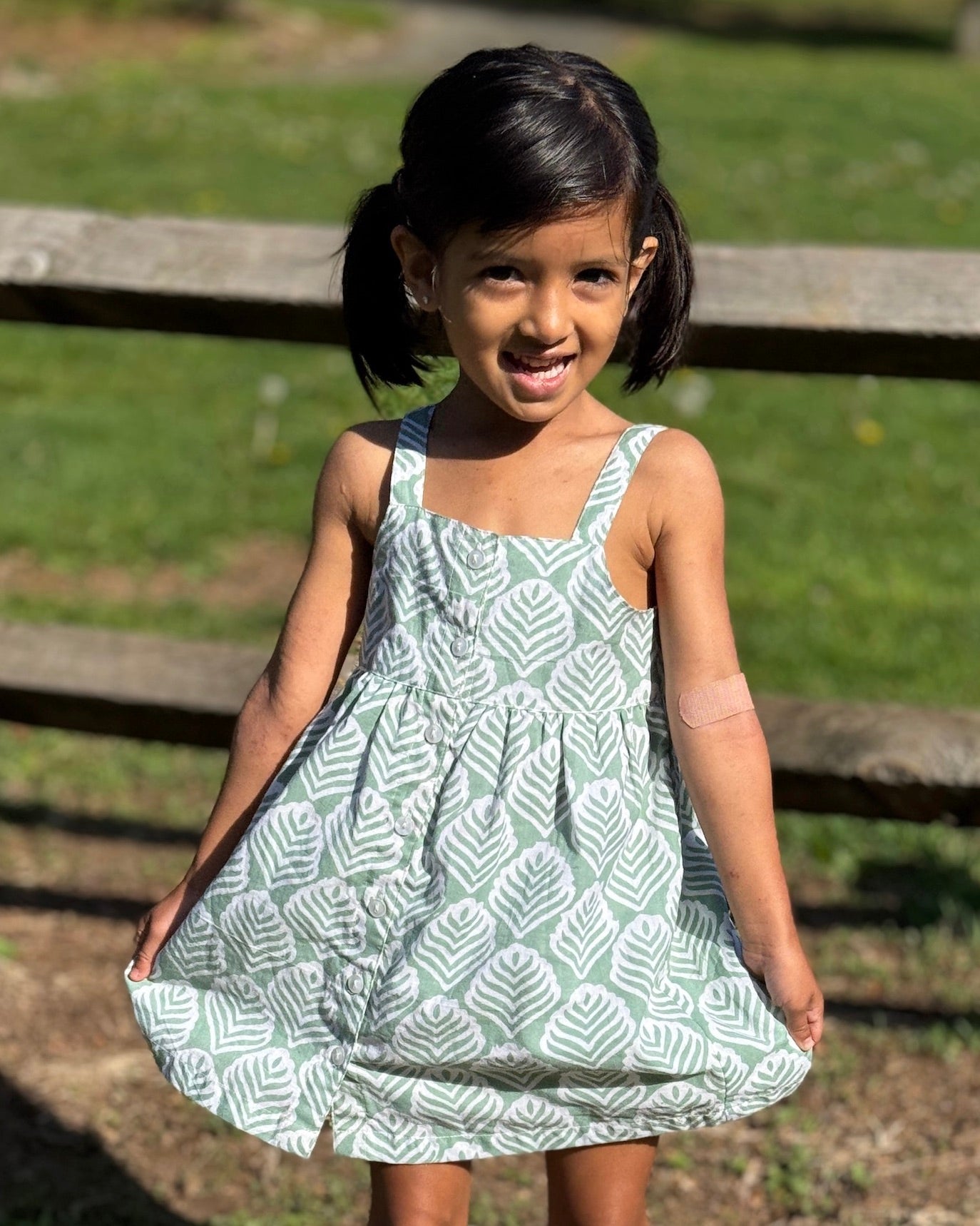 Girl wearing comfy cotton dress with leaf pattern 