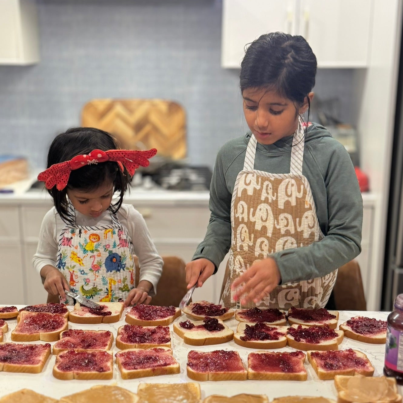 Kids wearing apron and making sandwiches