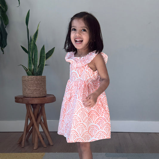 Toddler Girl wearing cotton dress with ruffle neckline 
