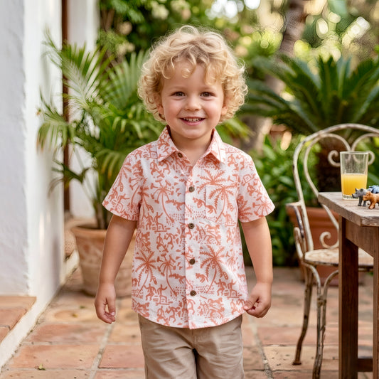 Young boy wearing short sleeve cotton button-up shirt enjoying summer day lightweight breathable outfit for travel and play