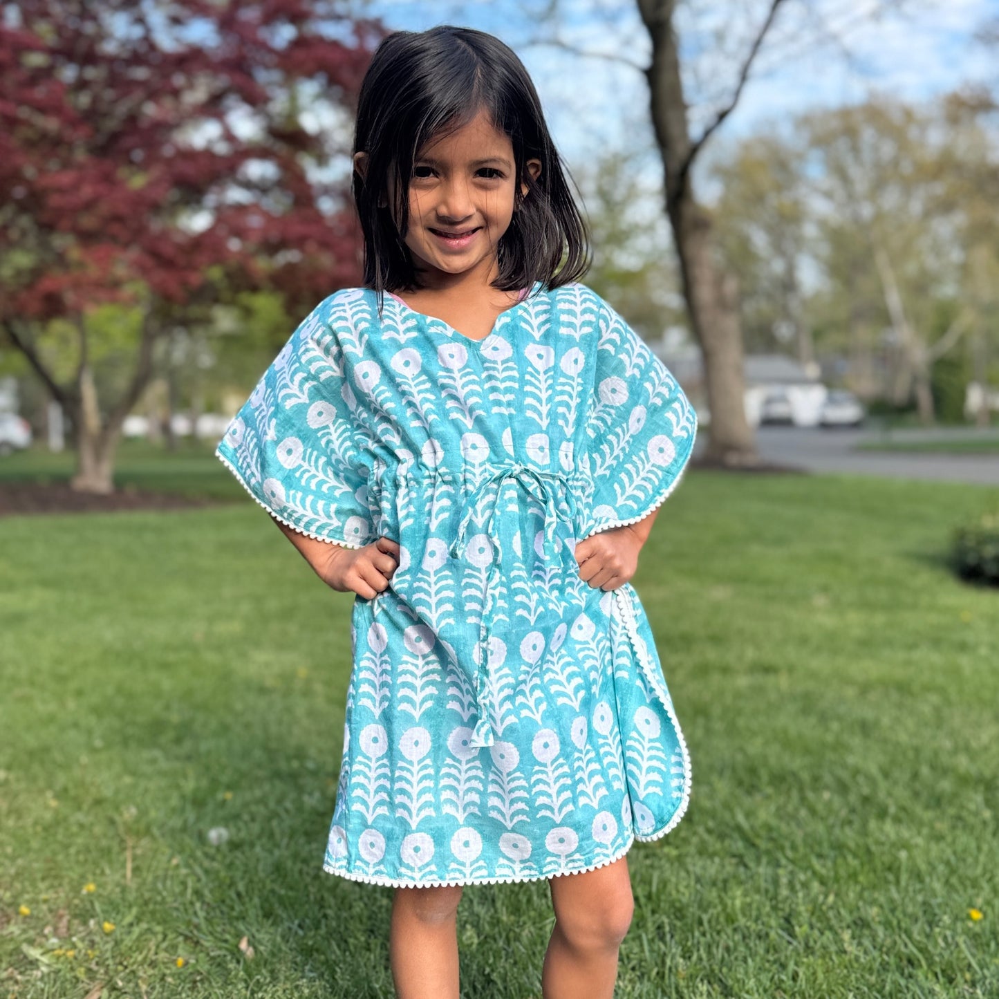 Young girl wearing cotton beach cover up kaftan enjoying summer vacation lightweight breathable resort wear