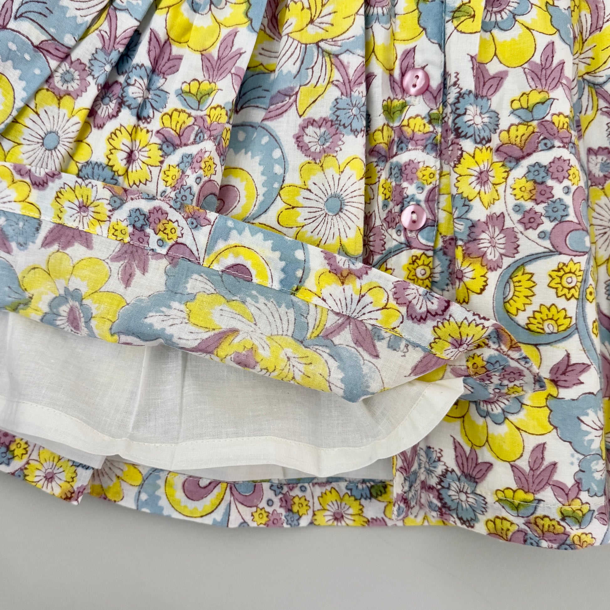 Close up of rainbow multicolor floral block print cotton sundress with soft lining